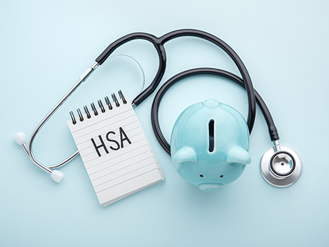 Health saving account, hsa concept, piggy bank with stethoscope on pastel blue background, top view