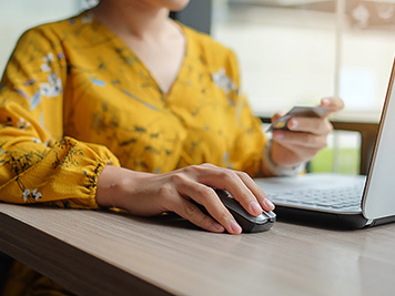 Asian woman holding credit card and using laptop for online shopping while making orders. internet, technology, ecommerce and online payment concept